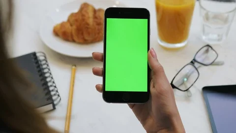 Woman using smartphone with green screen. Close-up video of woman's hands Stock Footage 72362073