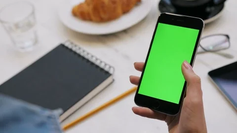 Woman using smartphone with green screen. Close-up video of woman's hands Stock Footage 72362109