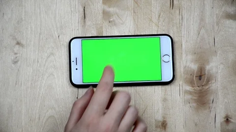 Woman is using smartphone with green screen. Girl's hand touching phone screen.  Stock Footage 101278982