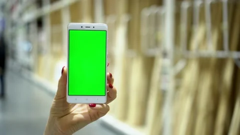 Woman using smartphone with green screen on the shopping center Stock Footage 132372923