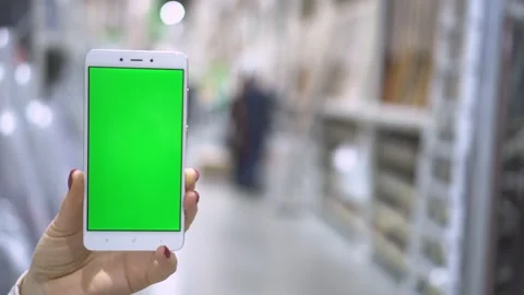 Woman using smartphone with green screen on the shopping center Stock Footage 135098511