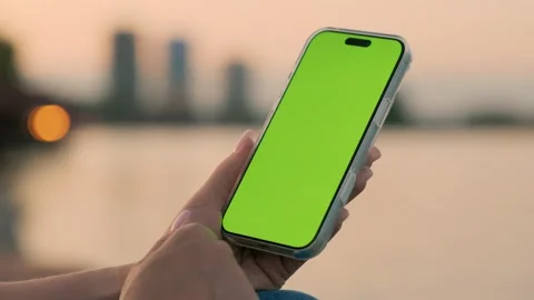Woman Using Smartphone with Green Screen Against of River on City Waterfront Stock Footage 341864924