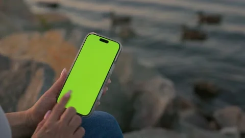 Woman Using Smartphone with Green Screen Against of River on City Waterfront Stock Footage 341865023