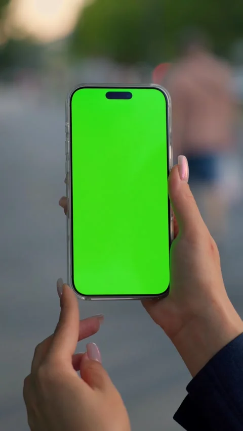 Woman Using Smartphone with Green Screen Mock-up On City Park. Vertical Video Stock Footage 341865250