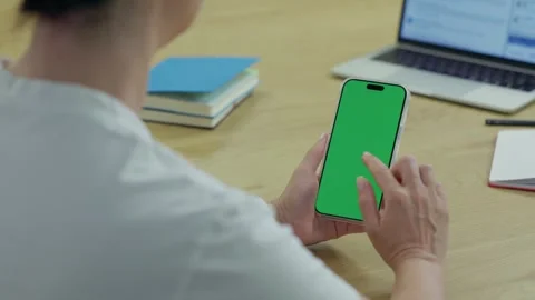 Woman Using Smartphone with Green Screen Chroma Key at Her Desk in Office Stock Footage 341865754