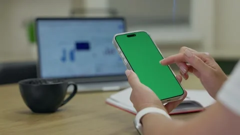 Woman Using Smartphone with Green Screen Chroma Key at Her Desk in Office Stock Footage 341865766