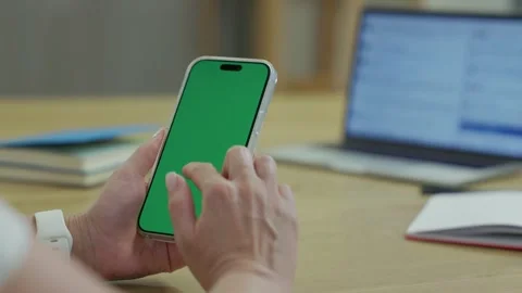 Woman Using Smartphone with Green Screen Chroma Key at Her Desk in Office Stock Footage 341865778