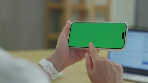 Woman Using Smartphone with Green Screen Chroma Key at Her Desk in Office Stock Footage 341865820