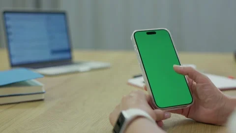 Woman Using Smartphone with Green Screen Chroma Key at Her Desk in Office Stock Footage 341865837