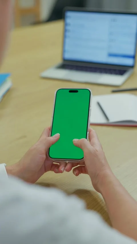 Woman Using Smartphone with Green Screen Chroma Key at Her Desk in Office Stock Footage 341866141