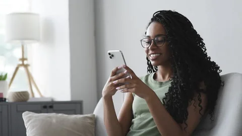 Woman using smartphone at home Stock Footage 161744010