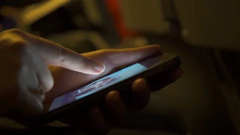 Woman using a smartphone inside an airplane Video stock 76573690