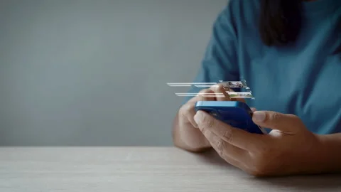 Woman using smartphone loading video with virtual screen Видео 342588663