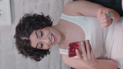 Woman using a smartphone is lying on the sofa.Video for the vertical story. Stock Footage 141123253