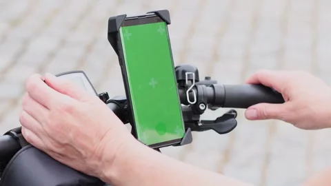 Woman using smartphone  to navigate maps app selecting bike route, green screen Stock Footage 270154862