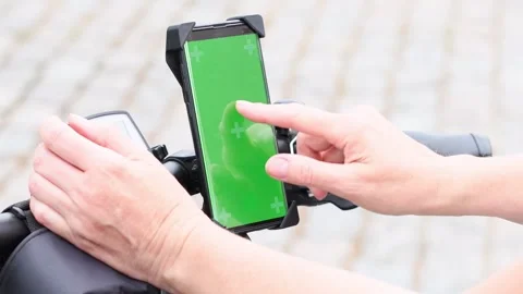 Woman using smartphone  to navigate maps app selecting bike route, green screen Stock Footage 270154872