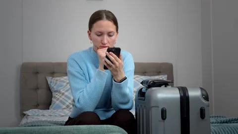 A woman using a smartphone, planning trips, Видео 307322541