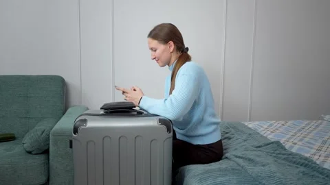 A woman using a smartphone, planning trips, Vidéo 307323202