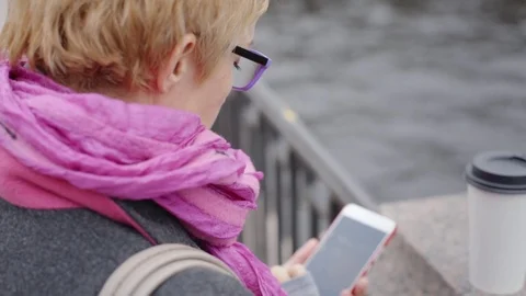 Woman using smartphone at river Stock Footage 80733939