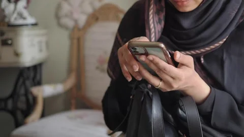 Woman using smartphone in a room Stock Footage 344098891