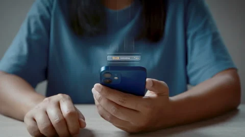 Woman using smartphone sends and receives email Stockbeeldmateriaal 342588661