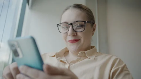 Woman using smartphone in slow motion, focused on business tasks Video stock 297363326