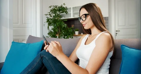 Woman Using Smartphone on Sofa 库存影片 115193929