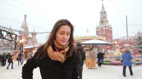 Woman using smartphone standing in the winter on the Red Square in Moscow, in Stock Footage 67384082