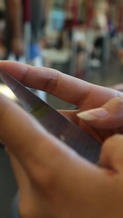 Woman Using Smartphone In Subway sits down to do some quick text messaging Stock Footage 317577116