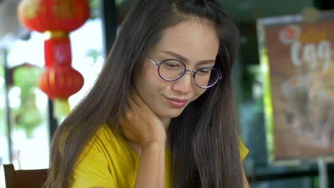 Woman Using Smartphone Touchscreen In Cafe. Asian Women Watching And Using Cell  Stock Footage 106800198