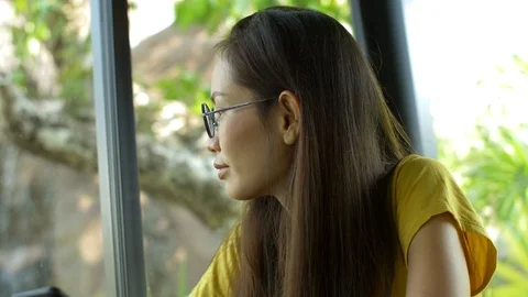 Woman Using Smartphone Touchscreen In Cafe. Asian Women Watching And Using Cell  Stock Footage 106800984
