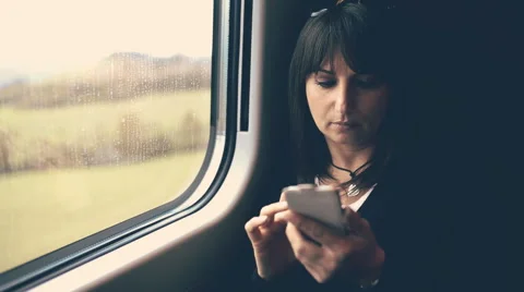 Woman using smartphone in train. Handheld shot Stock Footage 43423751