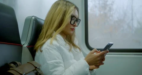 Woman Using Smartphone on Train Journey Stock Footage 323683597