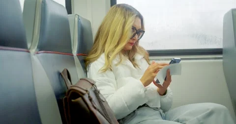 Woman Using Smartphone on Train Journey Stock Footage 323683642