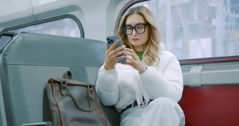 Woman Using Smartphone on Train with Leather Bag Vídeo Stock 323451628