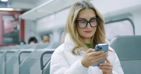 Woman Using Smartphone on Train in Modern Transit 스톡 동영상 323682353