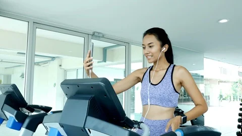 Woman using smartphone while exercise. Stock Footage 96975142