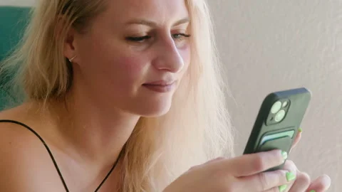 Woman using smartphone while relaxing at home Video stock 301272688