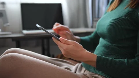 Woman using smartphone while sitting woman using app on cellphone at home. Be Stock Footage 202305026