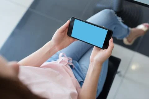 Woman using smartphone while sitting at a cafe Fotos de archivo