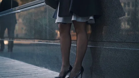 Woman using smartphone while waiting in the street Stock Footage 115250109