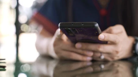 Woman using a smartphone while waiting for food Video stock 127367739