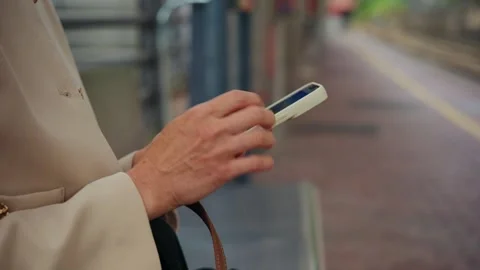 Woman Using Smartphone While Waiting for Public Transport Stock Footage 338343293