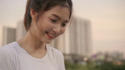 Woman using smartphone while walking on the street at city in the evening. Stock Footage 101918004