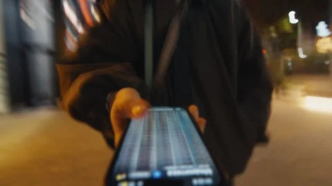 Woman using smartphone while walking in a blurry city at night Video stock 321258181