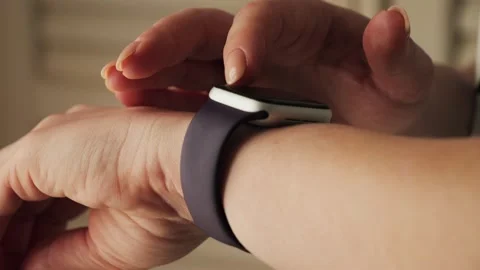 Woman using a smartwatch touchscreen. Wearing equipment during working day Stock Footage 314113763