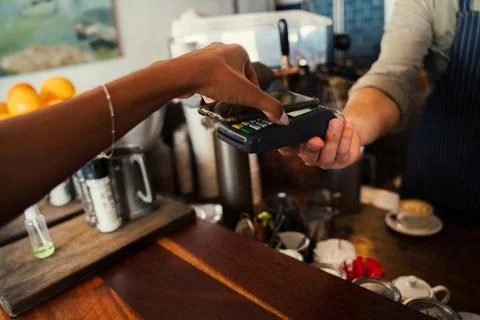 Woman using snap scan on cellular device to purchase coffee from funky cafe Stock Photos