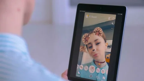 Woman using Snapchat multimedia messaging app with face mask on smartphone 스톡 동영상 109422633