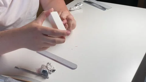 Woman using soft nail buffer to gently polish and smooth the surface of her.. Stock Footage 320954958