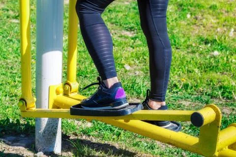 Woman using stepper training machine at outdoor Stock Photos